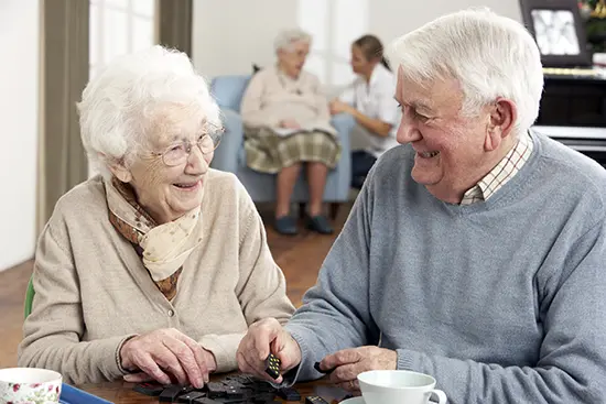 Independent living - A couple playing dominos at the Villas at Dominican Village